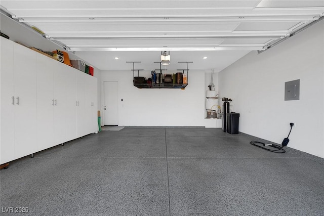 garage featuring electric panel and a garage door opener