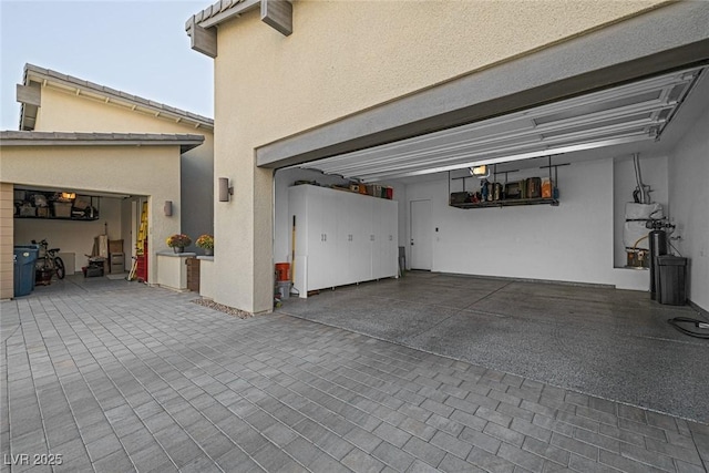 garage featuring a garage door opener and gas water heater