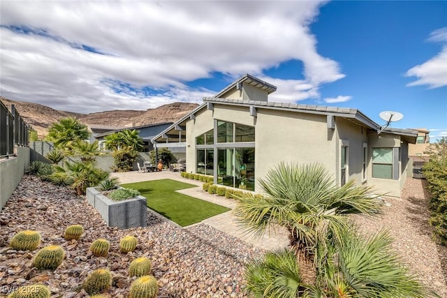 back of house with a patio area and a mountain view