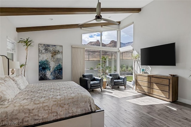 bedroom with ceiling fan, hardwood / wood-style floors, and vaulted ceiling with beams