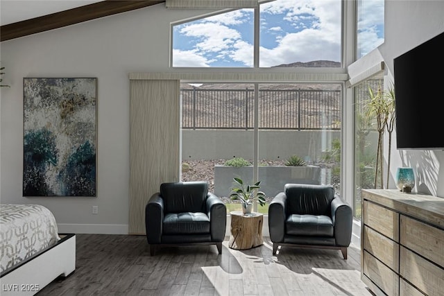 bedroom with hardwood / wood-style flooring and vaulted ceiling with beams