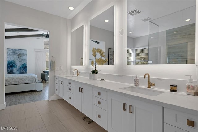 bathroom featuring tile patterned flooring, ceiling fan, and vanity