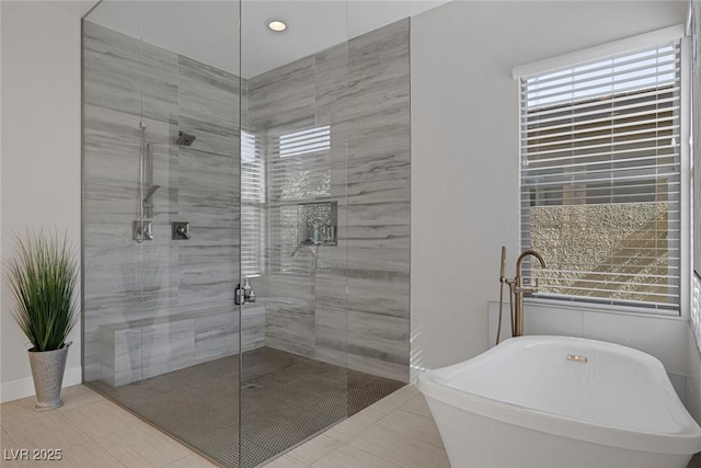 bathroom featuring tile patterned flooring and shower with separate bathtub