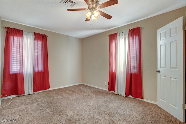 unfurnished room with ceiling fan and carpet