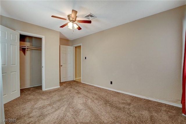 unfurnished bedroom featuring carpet, ceiling fan, and a closet