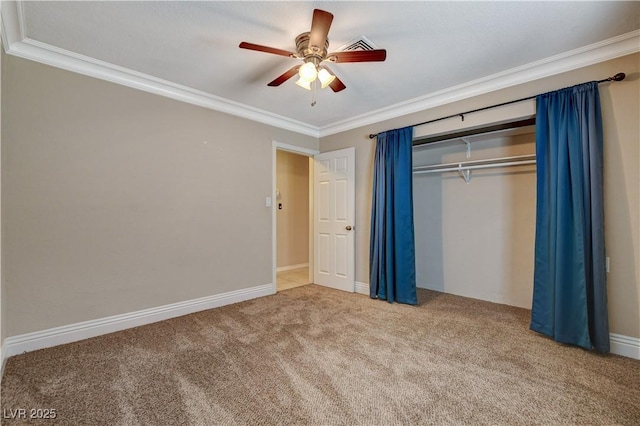 unfurnished bedroom with ornamental molding, carpet floors, ceiling fan, and a closet