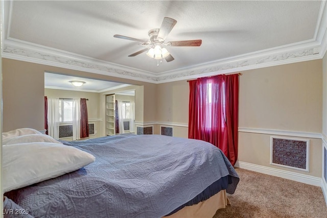 bedroom featuring crown molding, ceiling fan, and carpet