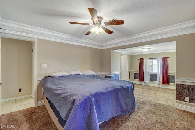 bedroom with ornamental molding, ceiling fan, and carpet flooring