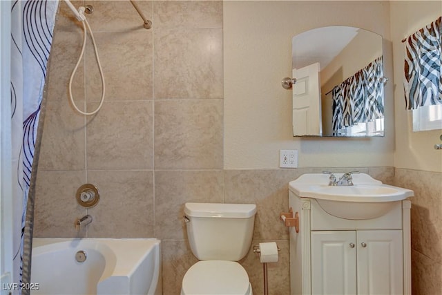 full bathroom with vanity, tile walls, shower / tub combo with curtain, and toilet