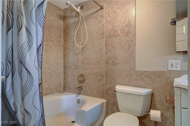 full bathroom with tile walls, vanity, toilet, and shower / bath combo with shower curtain