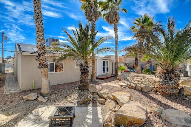 back of property with a patio area and an outdoor fire pit