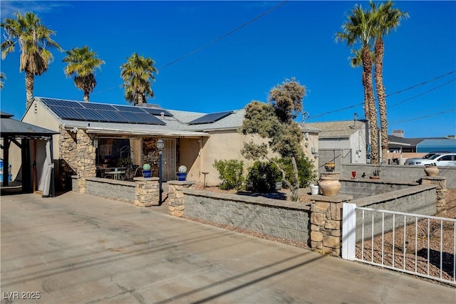 view of front facade with a gazebo and solar panels