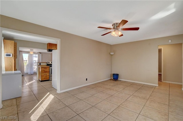 empty room featuring light tile patterned flooring and ceiling fan