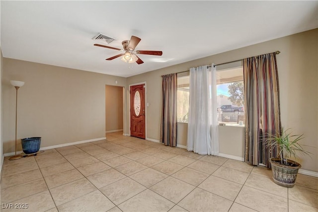 foyer entrance with light tile patterned floors and ceiling fan