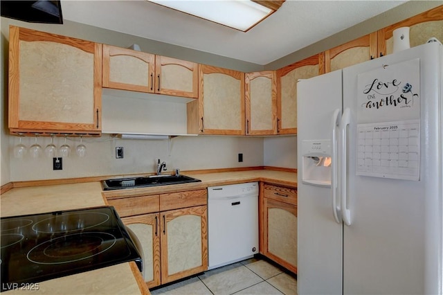 kitchen featuring light brown cabinets, sink, light tile patterned floors, and white appliances