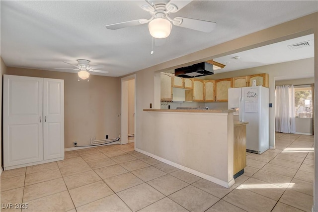 kitchen featuring light tile patterned floors, ceiling fan, extractor fan, white refrigerator with ice dispenser, and light brown cabinetry