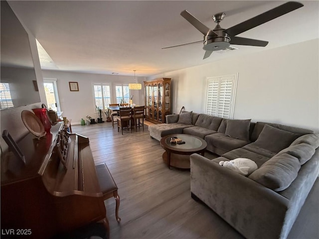 living room featuring hardwood / wood-style flooring and ceiling fan