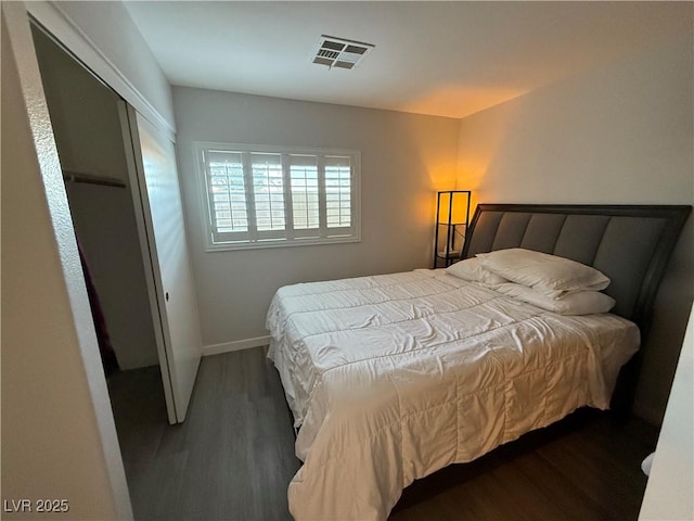 bedroom featuring a closet and dark wood-type flooring