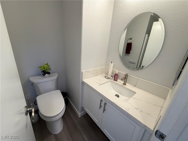 bathroom featuring hardwood / wood-style floors, toilet, and vanity