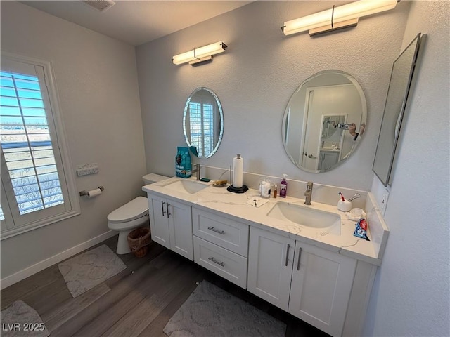 bathroom with hardwood / wood-style floors, toilet, and vanity