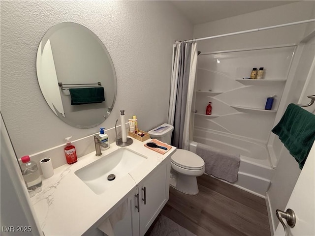 full bathroom with hardwood / wood-style floors, toilet, vanity, and shower / tub combo with curtain