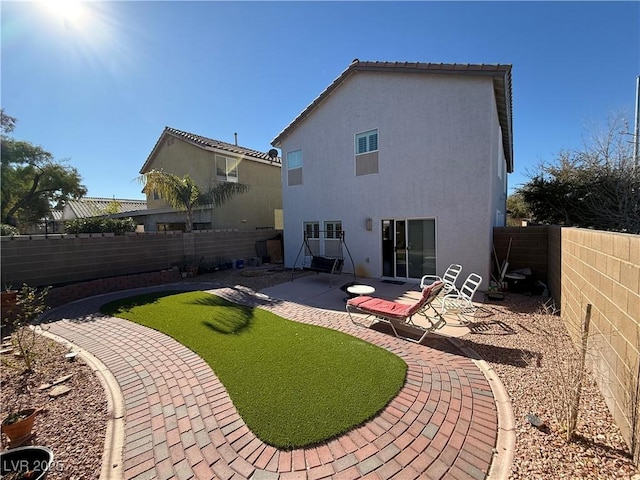 back of house with a patio