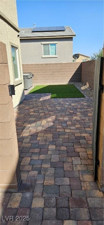 7050 Fossil Rim St, Las Vegas, NV 89084 - fenced backyard with a patio area
