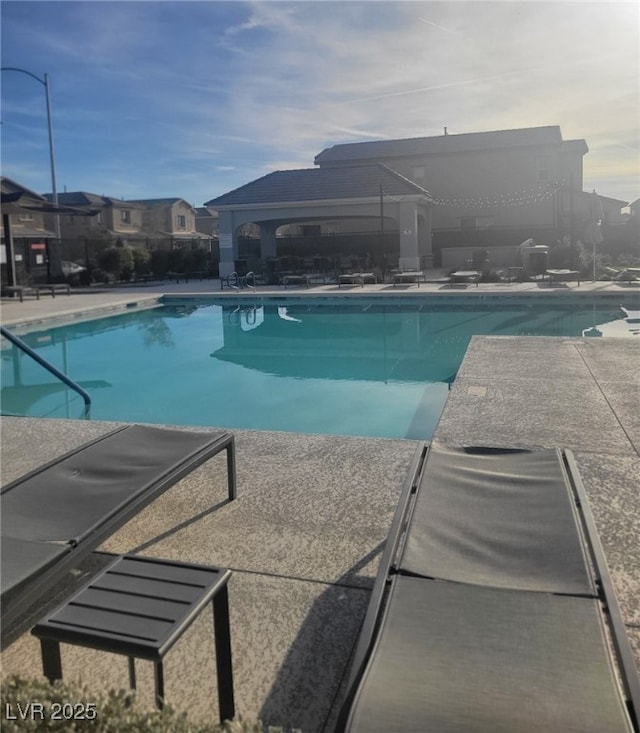 7050 Fossil Rim St, Las Vegas, NV 89084 - community pool featuring a patio