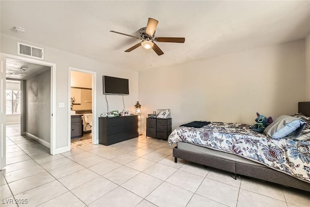 tiled bedroom featuring ensuite bath and ceiling fan