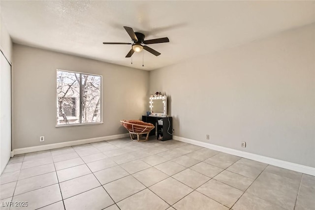 tiled spare room with ceiling fan