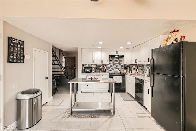 kitchen featuring black appliances, white cabinetry, decorative backsplash, and light tile patterned floors