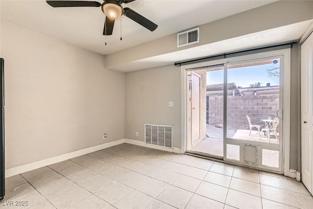 tiled empty room featuring ceiling fan