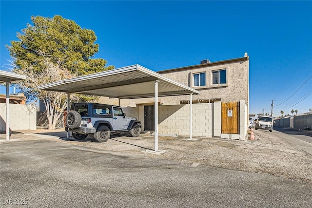 view of parking / parking lot featuring a carport