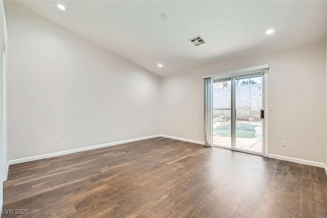 unfurnished room with visible vents, recessed lighting, dark wood-type flooring, and baseboards