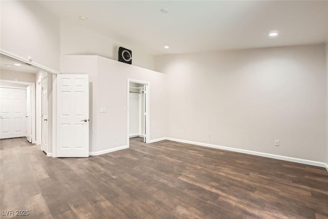 unfurnished bedroom featuring recessed lighting, baseboards, and dark wood finished floors