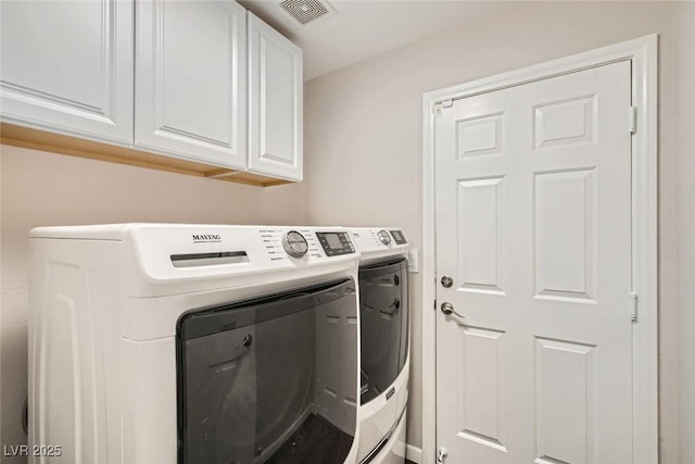 clothes washing area featuring cabinet space, visible vents, and washing machine and dryer