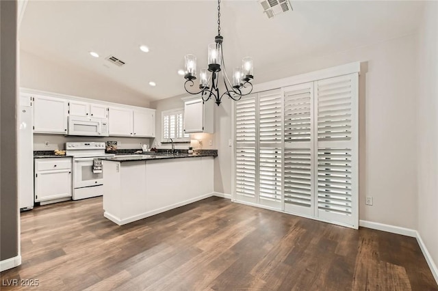 kitchen featuring visible vents, white appliances, dark countertops, and white cabinetry