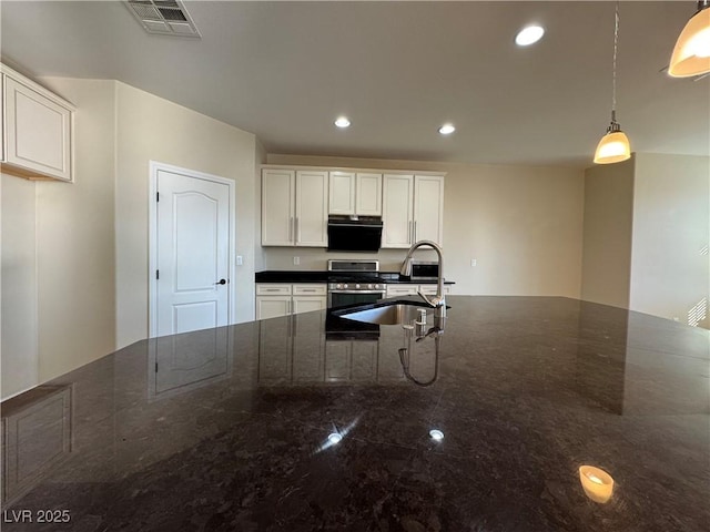 kitchen with sink, white cabinetry, decorative light fixtures, dark stone countertops, and stainless steel stove