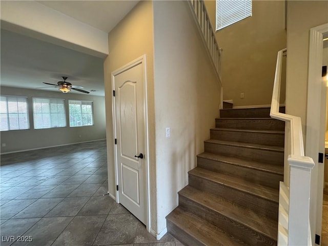 stairs with tile patterned floors and ceiling fan