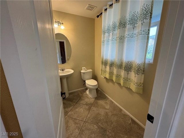 bathroom with tile patterned flooring, sink, and toilet