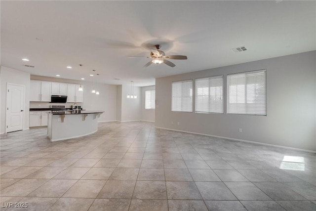10273 Aragon Crown Rd, Las Vegas, NV 89135 - unfurnished living room with light tile patterned floors, ceiling fan, recessed lighting, and baseboards