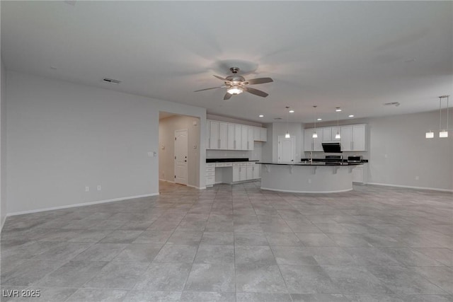 10273 Aragon Crown Rd, Las Vegas, NV 89135 - unfurnished living room featuring a ceiling fan, baseboards, and recessed lighting
