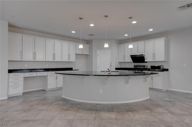 10273 Aragon Crown Rd, Las Vegas, NV 89135 - kitchen with dark countertops, stove, recessed lighting, and white cabinetry