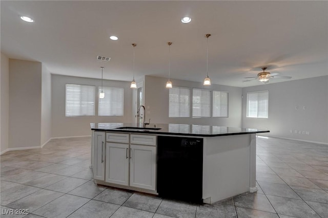 10273 Aragon Crown Rd, Las Vegas, NV 89135 - kitchen featuring black dishwasher, a sink, dark countertops, light tile patterned floors, and recessed lighting