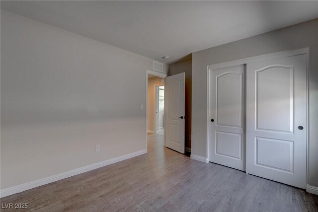 10273 Aragon Crown Rd, Las Vegas, NV 89135 - unfurnished bedroom with wood finished floors, baseboards, and a closet