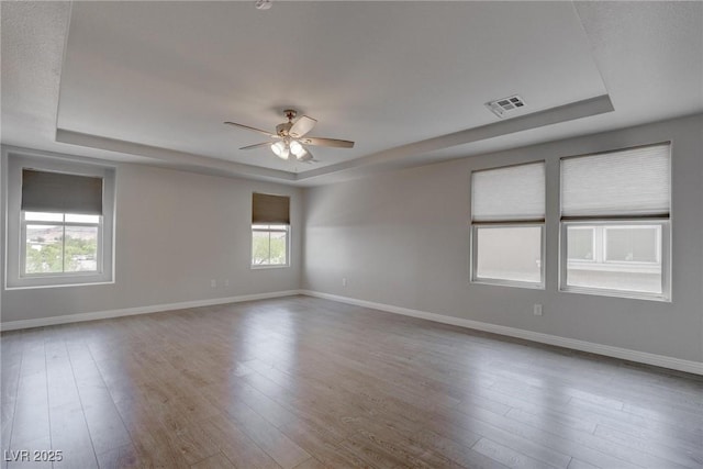 10273 Aragon Crown Rd, Las Vegas, NV 89135 - unfurnished room with a tray ceiling, a ceiling fan, and baseboards