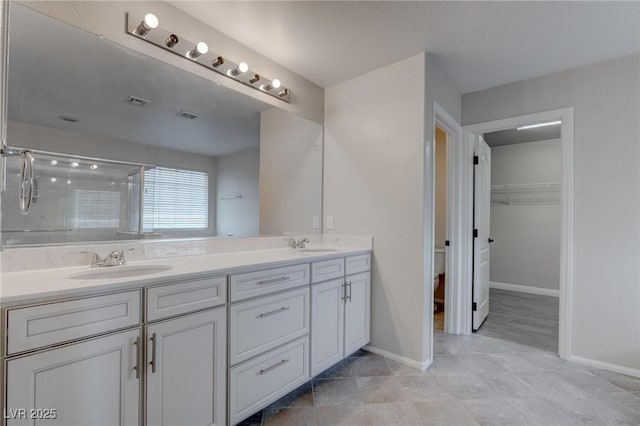 10273 Aragon Crown Rd, Las Vegas, NV 89135 - full bath with baseboards, double vanity, and a shower stall