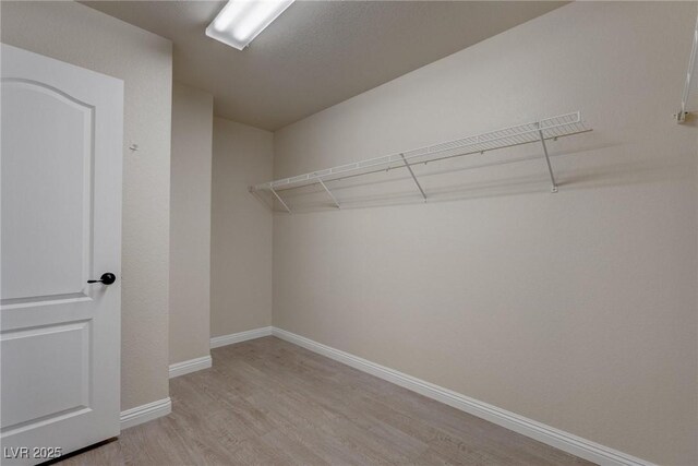 10273 Aragon Crown Rd, Las Vegas, NV 89135 - walk in closet featuring light wood-type flooring