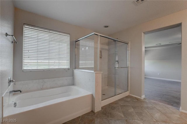 10273 Aragon Crown Rd, Las Vegas, NV 89135 - full bath featuring a shower stall, a bath, baseboards, and tile patterned flooring