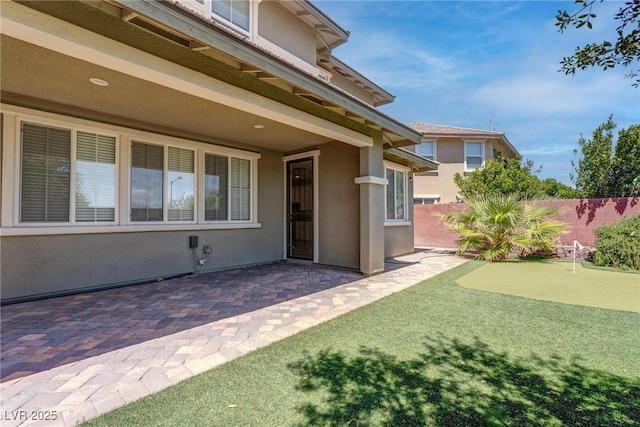 10273 Aragon Crown Rd, Las Vegas, NV 89135 - doorway to property featuring stucco siding, a patio, and fence